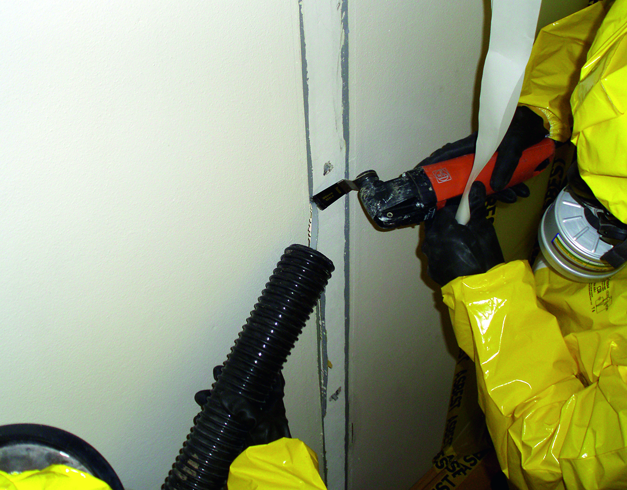 Removal of caulk using power tools and suction. 